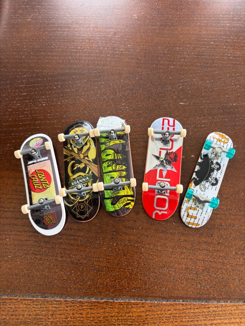Lot of 4 tech deck fingerboard skateboards and one additional